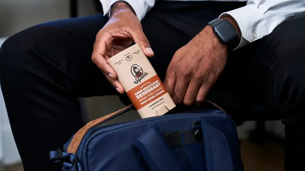 Een man met Dr Squatch Deodorant in tas