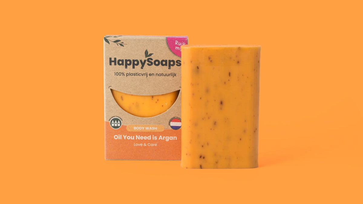 Oranje HappySoaps Oil You Need is Argan Body Wash Bar naast de verpakking